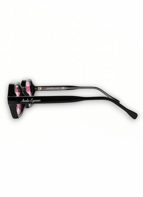 Zijaanzicht van de zwarte Aurélio Eyewear C3 zonnebril met roze glazen en merklogo op de pootjes.
